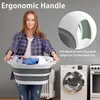 A woman is holding a collapsible laundry basket filled with clothes in front of a washing machine and a radiator. Voir les images du produit
