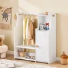 A white children's wardrobe with hanging clothes and shelves, set against a light beige wall. Anteprima dell’immagine prodotto