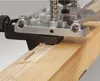 A woodworking tool is being used to cut a groove into a wooden plank. Voir les images du produit