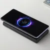 A smartphone is wirelessly charging on a black power bank. Anteprima dell’immagine prodotto