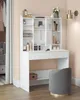 A white vanity table with storage and a gray stool in a room. Produktbild-Vorschau