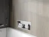 A built-in shelf in a bathroom wall with towels and a soap dispenser. Náhled obrázku produktu