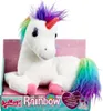 A plush unicorn toy is presented in its packaging, which features a pink background with subtle star patterns. Produktbild-Vorschau