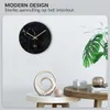 A modern living room setting with a wall clock and decorative items on a table. Anteprima dell’immagine prodotto