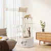 A cat tree with two cats in a living room setting, near a window and a wooden cabinet. Anteprima dell’immagine prodotto