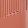 A close-up shot of the textured surface of a coral-colored suitcase, featuring the embossed 'travelite' logo. Produktbild-Vorschau