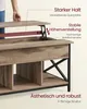 A person's hand is shown lifting the top of a wooden coffee table, revealing its internal mechanism and storage. Produktbild-Vorschau