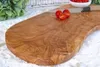 A close-up shot of a rustic olive wood cutting board with cherry tomatoes and a knife. Produktbild-Vorschau