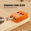 A close-up shot of a pocket hole jig being used to drill into a piece of wood, with sawdust visible. Náhled obrázku produktu