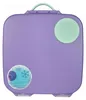 A top-down view of a purple lunchbox with a green handle and a green circular accent on the lid. There are two circular stickers on the lunchbox, one with a snowflake design and text, and another with a circular logo. Náhľad obrázku produktu