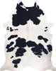 A cowhide rug with black and white markings. Produktbild-Vorschau