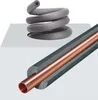 A cutaway view of insulated copper pipe, showing the insulation material and the copper pipe inside. Another section shows a coil of the same insulation material. Podgląd zdjęcia produktu