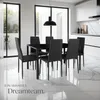 A modern dining room with a black dining table and chairs, set against a backdrop of large windows and a sleek kitchen. Náhled obrázku produktu