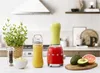 A kitchen counter with a red SMEG blender, a bottle of juice, a plant, and some fruit. Podgląd zdjęcia produktu