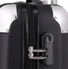 A close-up view of a black suitcase with silver corner protectors and a combination lock. Anteprima dell’immagine prodotto