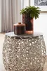 A close-up shot of a decorative side table with two items on top. Produktbild-Vorschau