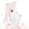 A pink and clear iPad case is shown in a dynamic, almost exploding composition, with pink shards scattered around it. Produktbild-Vorschau