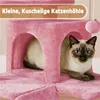 A Siamese cat is resting inside a pink cat tree. Produktbild-Vorschau