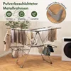 A multi-tiered drying rack with clothes hanging on it, placed in a room with a washing machine in the background. Anteprima dell’immagine prodotto