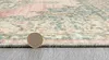 A close-up of a rug's edge with a coin for scale. Náhled obrázku produktu