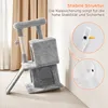 A grey cat tree is shown in a room with a beige curtain in the background. Inset images show how the cat tree attaches to the wall for stability. Podgląd zdjęcia produktu