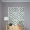 A corner of a room with a patterned wall, a wooden cabinet, and a floor lamp. Produktbild-Vorschau