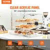 A clear acrylic display case filled with baked goods, set on a counter with a coffee grinder in the background. Náhled obrázku produktu