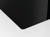 A close-up view of the corner of a black glass ceramic cooktop. Produktbild-Vorschau