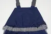 A close-up view of the upper part of a pair of dark blue overalls with gray elastic waistband and straps. Produktbild-Vorschau