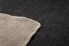 A close-up view of the corner of a blanket, showing the stitching and texture of the fabric. Produktbild-Vorschau