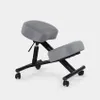 A gray ergonomic kneeling chair with a black metal frame and wheels, set against a light gray background. Produktbild-Vorschau