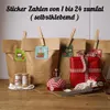 Brown paper bags with clothespins and decorative stickers, along with wrapped gifts and sewing supplies, arranged on a wooden surface. Produktbild-Vorschau