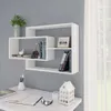 A white modern wall-mounted shelf unit filled with books and a small photo frame, placed above a white desk with stationery. Produktbild-Vorschau