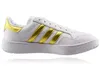 A side view of a white Adidas sneaker with gold stripes. Produktbild-Vorschau