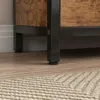 A close-up shot of the bottom of a piece of furniture, showing its legs and the floor. Podgląd zdjęcia produktu