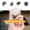 A hand holding a white Bluetooth tracker with multiple application options shown in small circles above. Anteprima dell’immagine prodotto