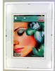 A framed picture of a woman's face with flowers. Produktbild-Vorschau