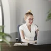 A woman is working on a laptop in an office. Produktbild-Vorschau