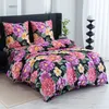 A bed with floral patterned bedding. Produktbild-Vorschau