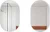 Two oval mirrors are shown against a white background. The left mirror reflects a bathroom interior with a showerhead and a ribbed wall. The right mirror reflects a minimalist interior with an orange upholstered bench. Podgląd zdjęcia produktu