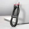 A black and red USB/USB-C charging cable is coiled and held by a strap, leaning against a laptop. Náhľad obrázku produktu