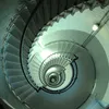 A view looking down a spiral staircase inside a lighthouse or similar structure. Produktbild-Vorschau