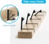 A product shot of a wall-mounted coat rack with hide-away hooks. Produktbild-Vorschau