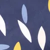 A close-up of a dark blue fabric with a repeating pattern of abstract floral shapes in white, yellow, and light blue. Voir les images du produit