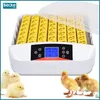 An incubator with yellow egg holders and a digital display, surrounded by chicks and ducklings. Náhľad obrázku produktu