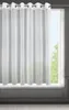 A white sheer curtain hanging in front of a window. Voir les images du produit