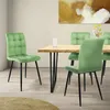 A dining room scene with a wooden table and green chairs.