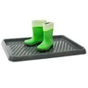 A pair of green rubber boots with white and green striped cuffs are placed on a gray boot tray. Podgląd zdjęcia produktu