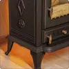 A close-up view of the base and lower side of a black cast-iron wood-burning stove. Voir les images du produit