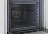 Interior view of an oven with a rack and fan. Voir les images du produit